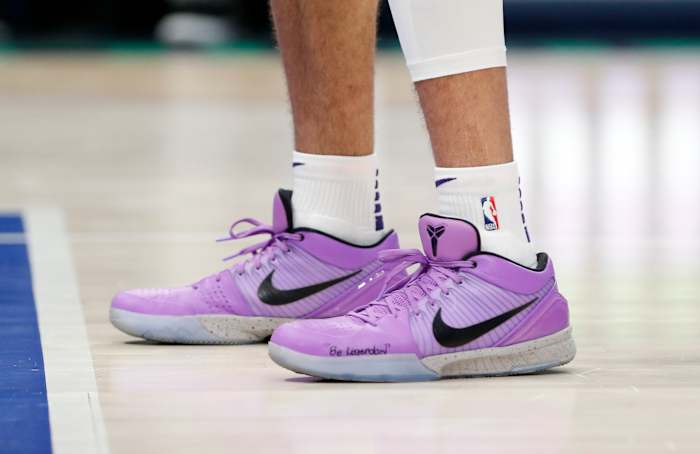 Devin Booker wears a pair of Nike Kobe 4 Protro in a violet colored PE.